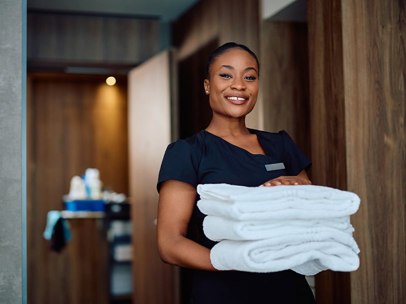 housekeeper-delivers-towels-with-smile-4-3