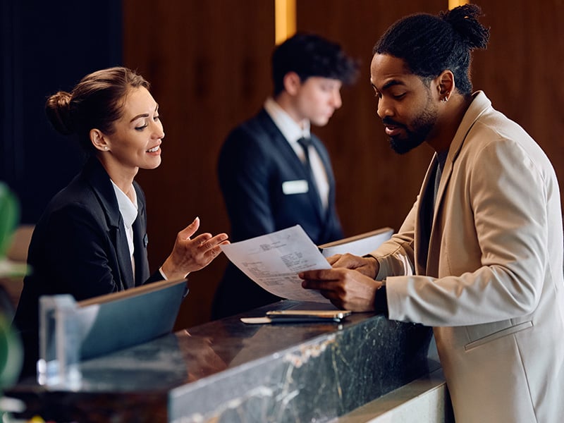 receptionist-helps-guest-at-front-desk-4-3